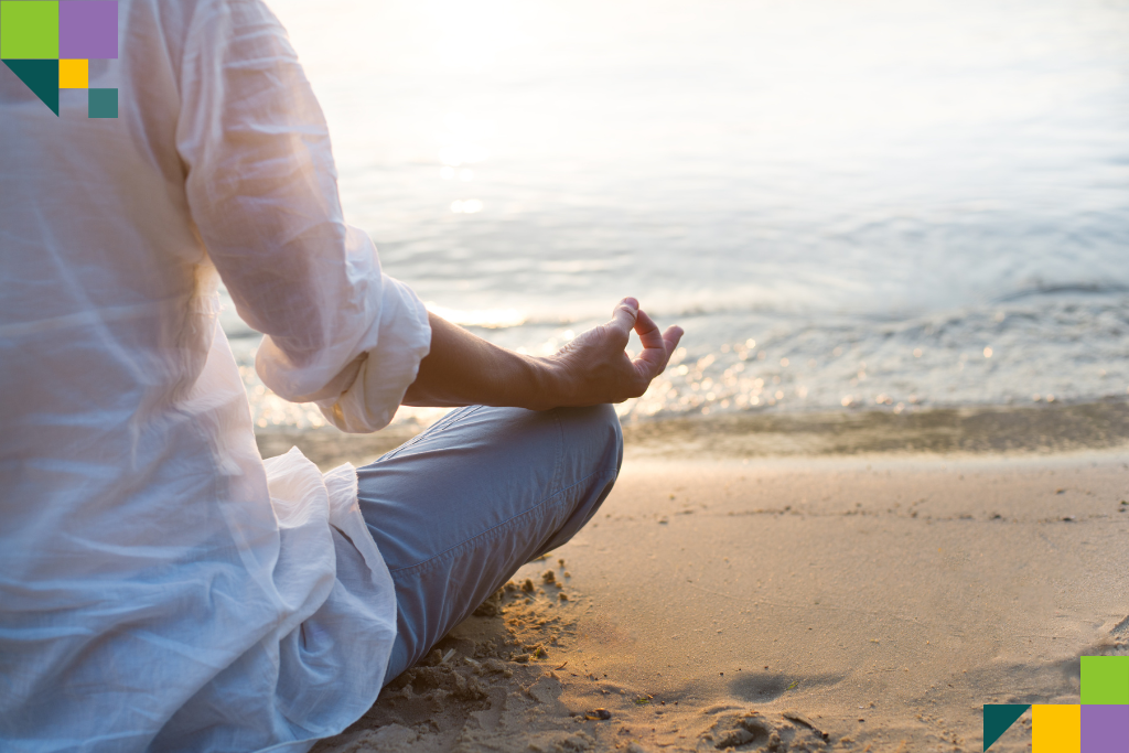 Man meditating by the beach water