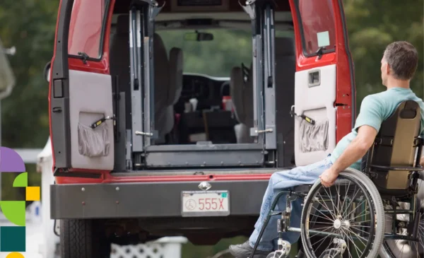Disabled man in a wheelchair positioned behind an open red van